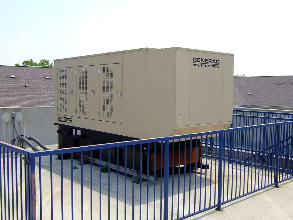 Generac Power Systems standby generator installed on a pad outside a building