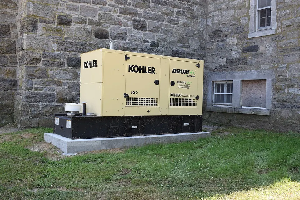 Kohler standby generator on a concrete pad beside a house
