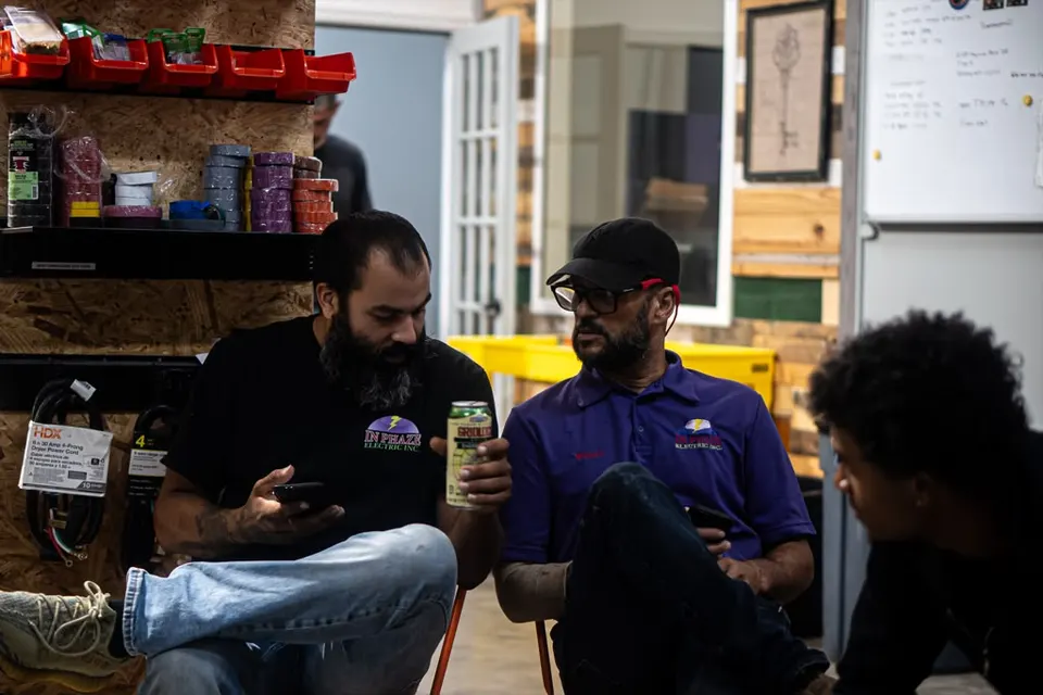 William Rivas, Joshua Martinez and Alex Thomas talking in the In Phaze Electric warehouse
